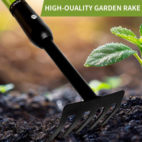 Close-up of Handy Tiny Garden Rake With Telescoping Handle 27 To 39 Inches Non Slip Grip next to plant in soil.
