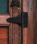 10 Pack 2 Inch Matte Black T Strap Shed Hinges For Barn Doors And Gates Heavy Duty Strap Hinges Set mounted on a wooden door
