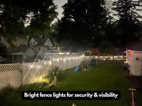 Ambience Pro 48 Ft Solar Outdoor String Lights With 15 Shatterproof 1W LEDs illuminating a backyard fence at night