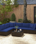 7 Piece Outdoor Wicker Patio Furniture Set for Six With Cushions, 2 Throw Pillows, Rattan Sectional on patio with navy cushions