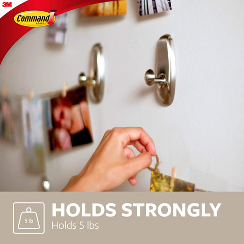 Large Timeless Wall Hook Holds Up To Five Pounds With Two Strips Brushed Nickel Finish Damage Free No Tools Hanging Decor In Living Spaces Great For Hats And Accessories In Any Room No Tools Required showcasing strength by holding pictures easily.