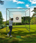 Person practicing full swing in 10x10x10Ft Golf Practice Net Cage With Metal Frame For Backyard Hitting And Batting Netting