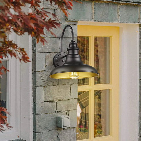 Outdoor Dusk To Dawn Sensor Wall Light Fixture Dome 12.3 Inch Black Finish Industrial Sconce on stone wall, lit up at dusk.