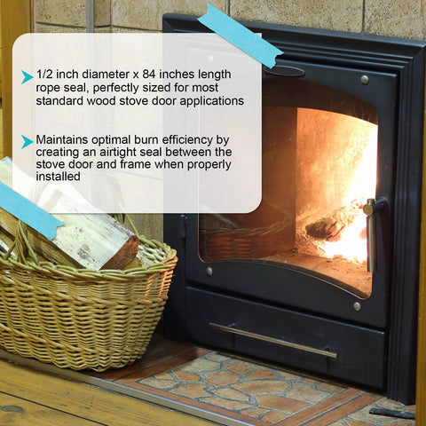 Front view of black wood stove with glass door and metal handle; flames visible inside and a wood basket beside.