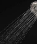 Kubos Exhilaration High Pressure Handheld Shower Head Matte Black Finish, 2 GPM, water flow from round showerhead on black background