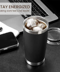 Eight Tough As Nails Twenty Ounce Double Wall Insulated Stainless Steel Tumblers With Secure Lids And Straws That Keep Your Sippin Frosty Or Steaming Hot All Day Long In Sleek Black Finish with ice drink on desk.