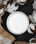 Overhead view of Cotton Chalk Finish Furniture Paint 16oz Matte White Chalk Mineral DIY for wood, metal, and more, surrounded by cotton bolls.
