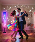 Couple dancing beside Smart Floor Lamp With RGB LED Color Changing Lights App Control DIY Mode Music Sync Alexa And Google Assistant Compatible Standing Lamp With White Fabric Shade For Living Room Bedroom And Play Room
