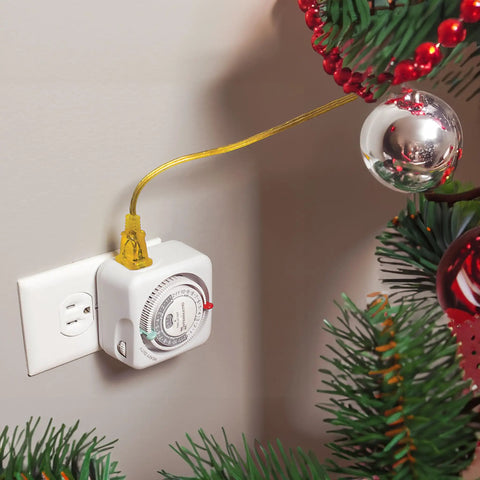 Heavy Duty 24 Hour Indoor Mechanical Plug In Timer With Easy Manual Override And Customizable Scheduling For Lighting Fans And Small Appliances A No Brainer Energy Saver plugged into wall near Christmas tree