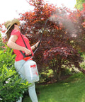 Person using 1-Gallon Handheld Farm and Garden Sprayer with Easy Fill Funnel Top and Large Secondary Opening in garden