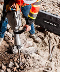 Worker using 110 Volt 1520 Watt Heavy Duty Electric Demolition Jack Hammer Workhorse For Concrete Breaking MKB 65A with case