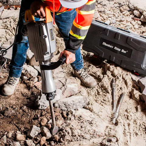 Worker using 110 Volt 1520 Watt Heavy Duty Electric Demolition Jack Hammer Workhorse For Concrete Breaking MKB 65A with case