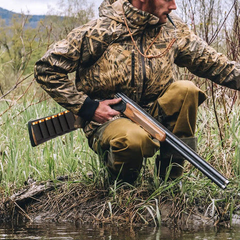Hunter with shotgun featuring 8 Round Tactical Shotgun Shell Holder for Buttstock 12 Gauge 20 Gauge Ammo Carrier outdoors