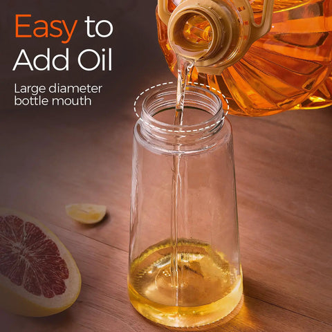 Smooth Operator Sixteen Oz Glass Olive Oil Spray Bottle With Dual Pour And Sprayer Function Drip Free Build For Grilling Roasting And Healthy Cooking Bpa Free Matte Black Kitchen Ace pouring oil into a large mouth glass bottle.