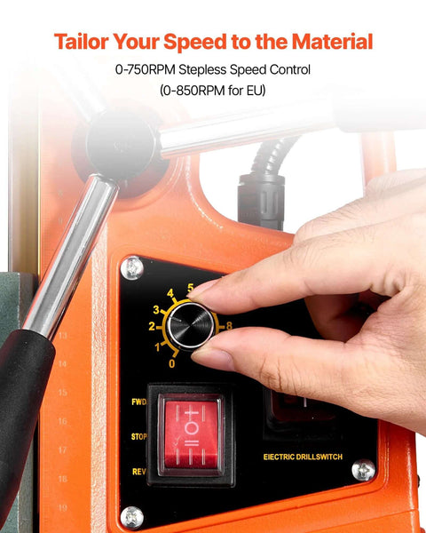Magnetic drill press with orange housing and black control panel featuring a yellow speed dial knob