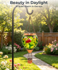 Glass Hot Air Balloon Solar Lantern With Flame Hand Painted Artwork Realistic Flickering Flame Hummingbird Accent Rustproof Metal Outdoor Solar Light For Garden Or Yard Easy Setup And Eco Friendly hanging in garden with flowers.