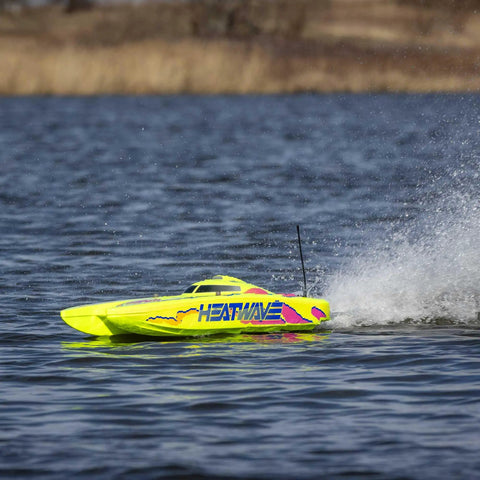 Blackjack 24 Inch V2 Catamaran Brushless RC Boat with Heat Wave Visual speeding on water, showing bold two-tone trim.