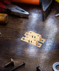 Brass Double Ball Tension Roller Door Catch Set 50mm Adjustable with tools on wood surface