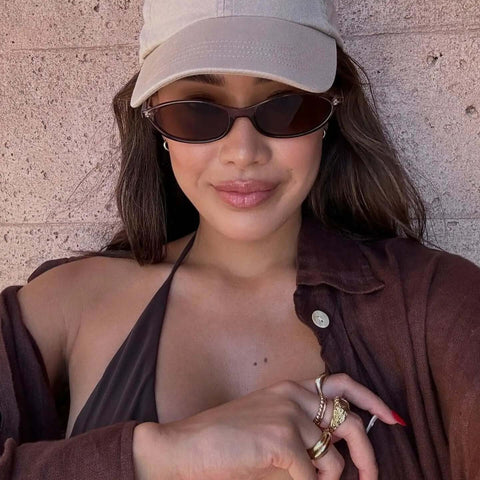 Woman wearing Retro Oval Sunglasses For Women With Cat Eye 90s Vibe Lightweight Narrow Frames UV Protection Sun Glasses