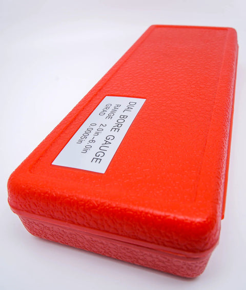 Red plastic case for a dial bore gauge; bore range 2-6 inches, 0.0005 inch graduations.