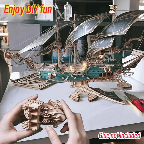 Hands assembling Vintage Steampunk DIY Mechanical Model Kit for the Corsair Airship in Deep Green with hollow frame design.