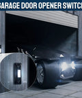 Garage door opener switch mounted on stone wall beside open garage, black metal button with white LED light