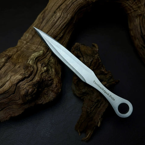 Kunai Inspired Throwing Tool With Full Tang Stainless Steel Build on wooden background