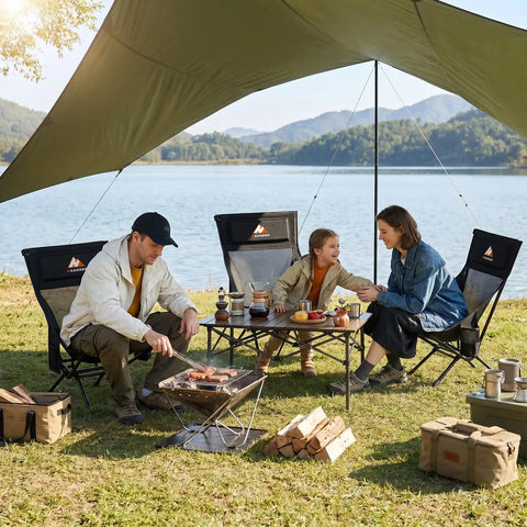 Family enjoying picnic with Armless Rocking Camping Chair With Spring Action Tech, Heavy Duty Mesh Seat, by lakeside campsite, under canopy.