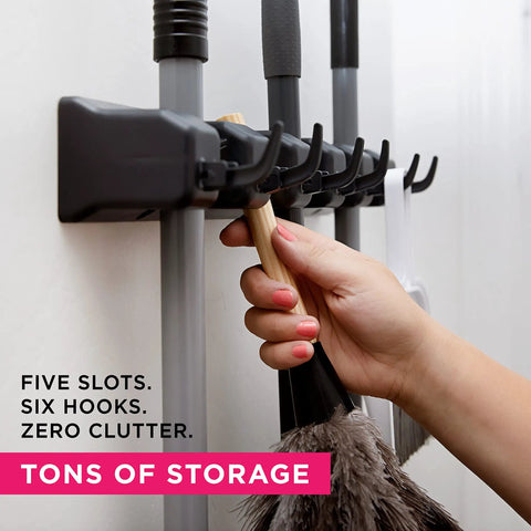 Five Slot Broom Holder With Self Adhesive Mop Gripper No Drilling Wall Mount Organizer holding cleaning tools in use