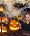 14 Pack Solar Torches With Flickering Flames 12 LED Outdoor Tiki Torch Lights Waterproof For Garden Patio Yard Pathway Create Cozy Mood Lighting For Parties BBQs Camping And Xmas Decor, showing height and Halloween decor.