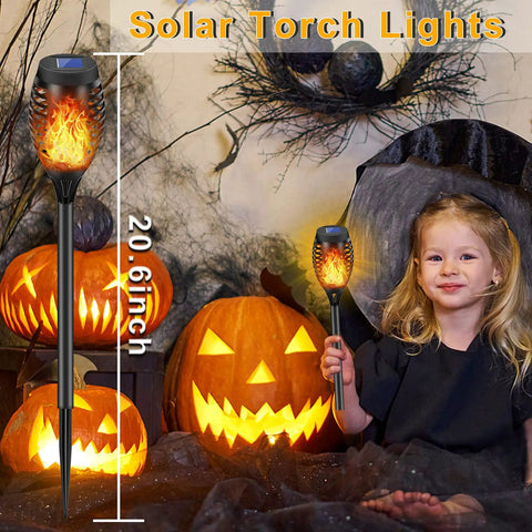 14 Pack Solar Torches With Flickering Flames 12 LED Outdoor Tiki Torch Lights Waterproof For Garden Patio Yard Pathway Create Cozy Mood Lighting For Parties BBQs Camping And Xmas Decor, showing height and Halloween decor.