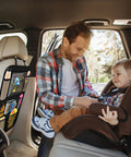 Father with toddler in car seat, showing backseat car organizer with 8 large pockets and tablet holder for kids and toddlers.