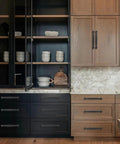 2 Pack 3 Inch Center Hole Matte Black Cabinet Pulls on kitchen cabinets in a modern setting.
