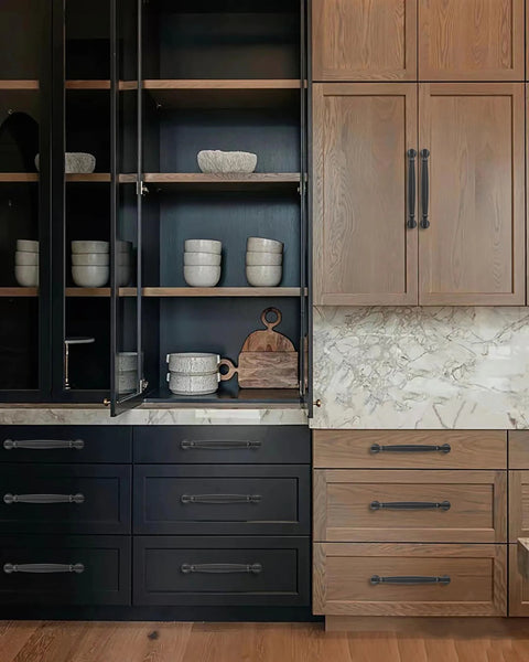 2 Pack 3 Inch Center Hole Matte Black Cabinet Pulls on kitchen cabinets in a modern setting.