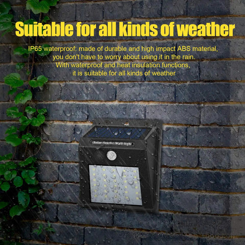 Solar Motion Sensor Outdoor Lights 30 LED 4 Pack With Motion Activated Security Lighting No Fuss Solar Powered Exterior Wall And Gutter Sconce Lamps For Home Safety Weatherproof Black on brick wall in rain