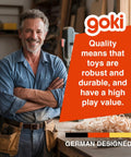 Man smiling in a woodworking shop with text overlay highlighting quality and durability of German-designed toys.