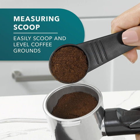 Measuring scoop leveling coffee grounds into extra large portafilter of 4 Shot Steam Espresso Cappuccino Latte Maker With Stainless Steel Frothing Pitcher, Extra Large Portafilter, And Barista-Grade Steam Brew For Rich Cafe Quality Home Brews