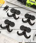 Heckin Durable Four Piece Cast Iron Beard Wall Hooks For Old School Farmhouse Charm And Dang Tough Rustic Decor Hanging Rack For Coats Scarves Towels Keys With Mounting Hardware Included on a wooden surface.