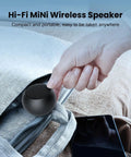 Person placing Pocket Bluetooth Speaker With Big Bass, 5W Portable Wireless Speaker, IPX7 Waterproof, into a bag for travel.