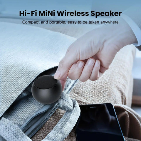 Person placing Pocket Bluetooth Speaker With Big Bass, 5W Portable Wireless Speaker, IPX7 Waterproof, into a bag for travel.