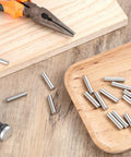 15 Pack One Quarter Inch Stainless Steel Shelf Peg Pins With Chamfered Ends For Easy Insertion, on wooden surface