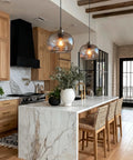 Cool Blue Bubble Glass Pendant Light For Kitchen Island And Dining Room Hand Blown Glass Globes Modern Brushed Nickel Finish 9 Inch Diameter Over Sink Bar Table Lighting in a modern kitchen setting.