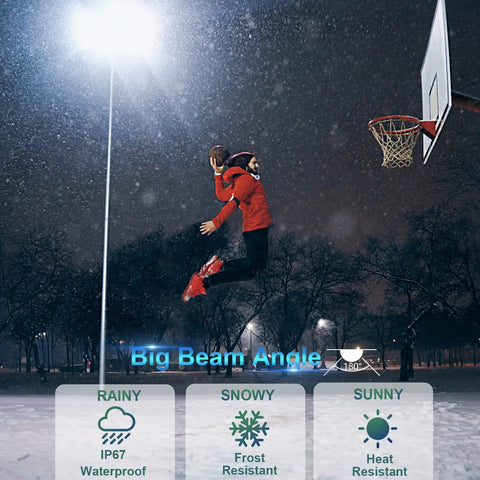 Basketball player dunking at night under Beastly 600W Outdoor LED Flood Lights, demonstrating IP67 waterproof and frost resistance.