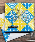 Colorful handmade birthday card with intricate blue and yellow patterns on wooden background, featuring 'Happy Birthday' text.