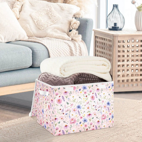 Heavy Duty Foldable Storage Bin With Secure Flip Top Lid And Collapsible Build For Bedroom Essentials holding three rolled blankets.