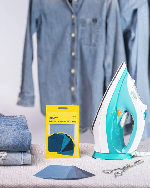 Denim Iron-On Patch Kit With 12 Patches In Three Blue Shades For Inside And Outside Glue Durable Repair For Jeans And Jackets Three Inch By Four And A Quarter Inch Easy DIY Embellishment To Patch Holes And Level Up Your Style. Iron-on denim patch kit with 12 blue patches, folded jeans, and iron