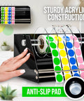 Rock Solid Acrylic Label Dispenser With Grippy Non Slip Base for sticker rolls, showing multi-color dots and anti-slip pad.