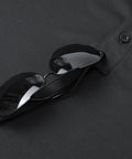 Close-up of black Men's Quick Dry Golf Polo Tee With Breathable Mesh Short Sleeve Shirt Moisture Wicking Classic Fit for sports.