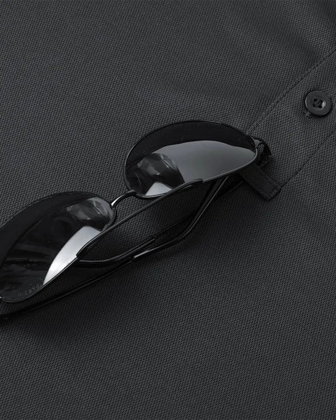 Close-up of black Men's Quick Dry Golf Polo Tee With Breathable Mesh Short Sleeve Shirt Moisture Wicking Classic Fit for sports.