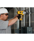 Man using Corded Hammer Drill Kit With Half Inch Capacity And Ten Amp Power For Masonry Wood And Steel Drilling Dual Mode Hammer